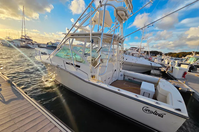 Slide: The Image of 2007 Carolina Classic 28 Express boat docked at marina during sunset. - 25