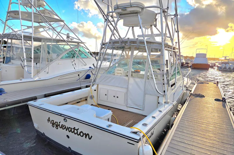 Slide: The Image of 2007 Carolina Classic 28 Express boat docked at sunset with clear skies. - 27