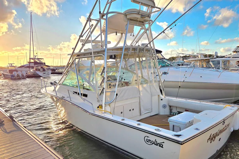 Slide: The Image of 2007 Carolina Classic 28 Express boat docked at marina during sunset. - 28