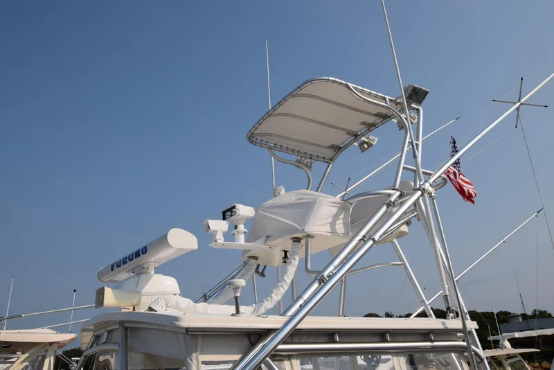 Slide: The Image of 2007 Carolina Classic 28 Express boat with radar and antennas against clear sky. - 6