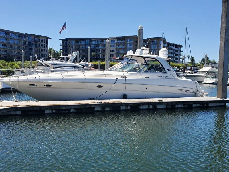 The Image of 2001 Sea Ray 460 Sundancer yacht docked in marina with buildings in background. - 0