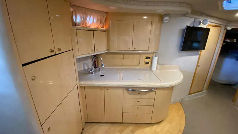 Slide: The Image of 2001 Sea Ray 460 Sundancer yacht kitchen with modern cabinetry and appliances. - 16