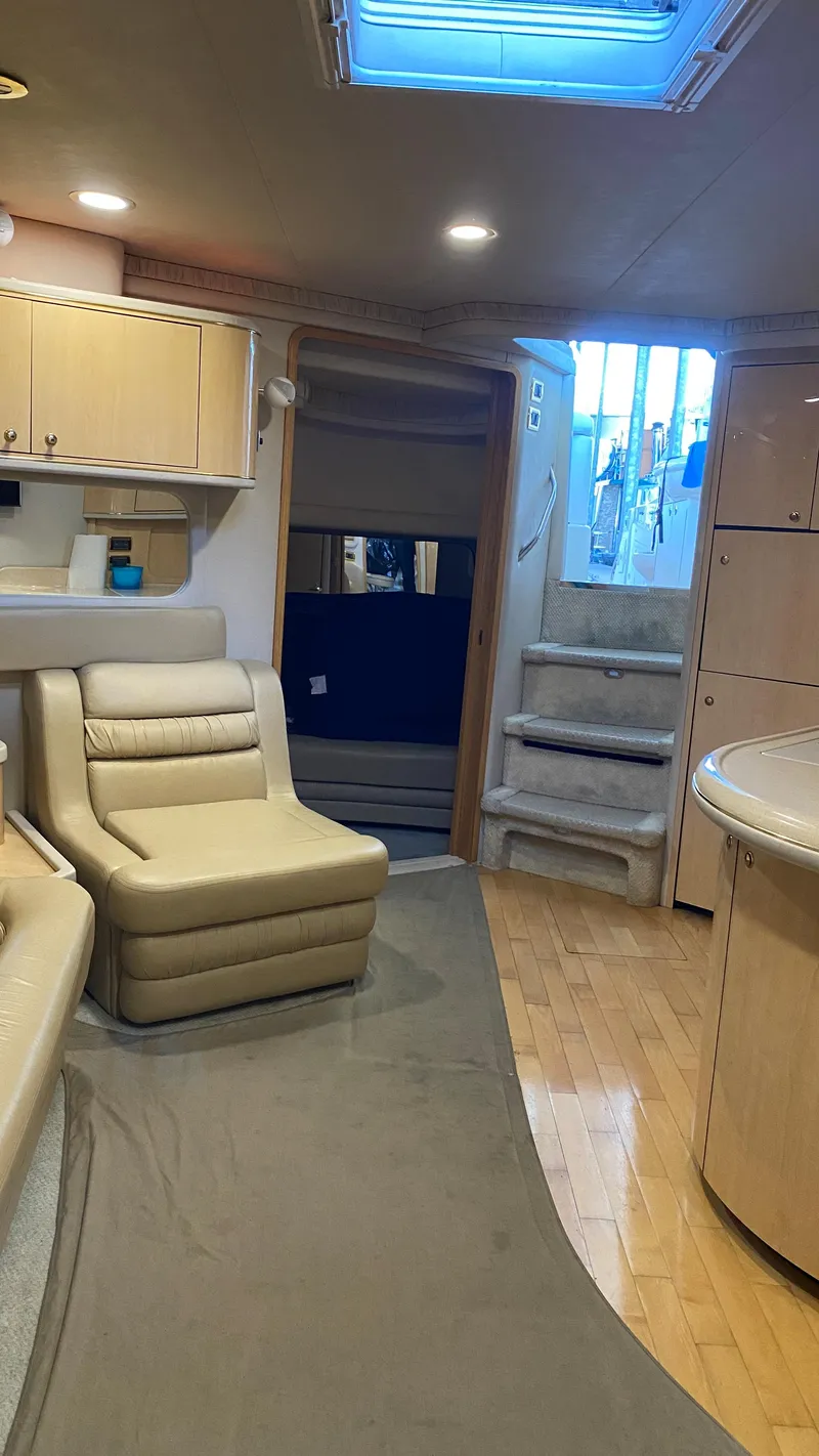 Slide: The Image of Interior of 2001 Sea Ray 460 Sundancer yacht with beige seating and wooden flooring. - 20