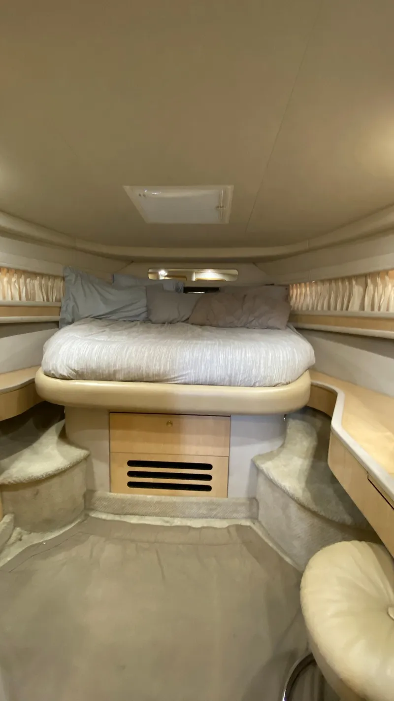 Slide: The Image of Interior cabin of 2001 Sea Ray 460 Sundancer with cozy bed and seating area. - 22