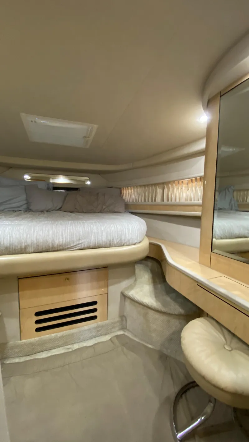 Slide: The Image of 2001 Sea Ray 460 Sundancer cabin interior with bed and vanity. - 23