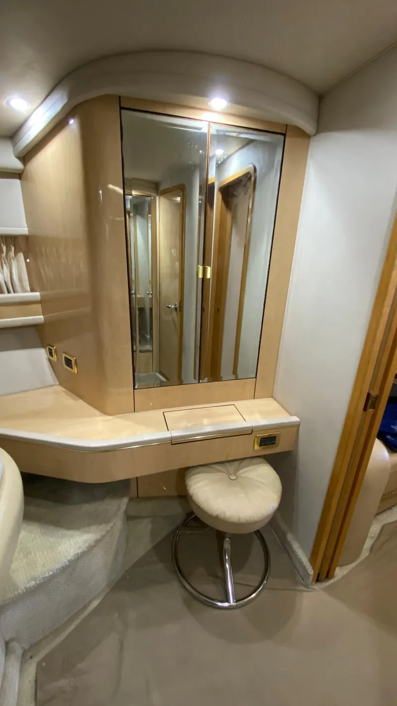 Slide: The Image of 2001 Sea Ray 460 Sundancer interior vanity area with mirror and stool. - 25