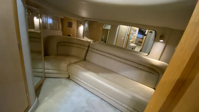 Slide: The Image of Interior of 2001 Sea Ray 460 Sundancer with beige leather seating and mirrored walls. - 27