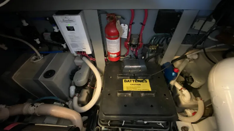 Slide: The Image of Engine compartment of a 2001 Sea Ray 460 Sundancer yacht with battery and fire extinguisher. - 30
