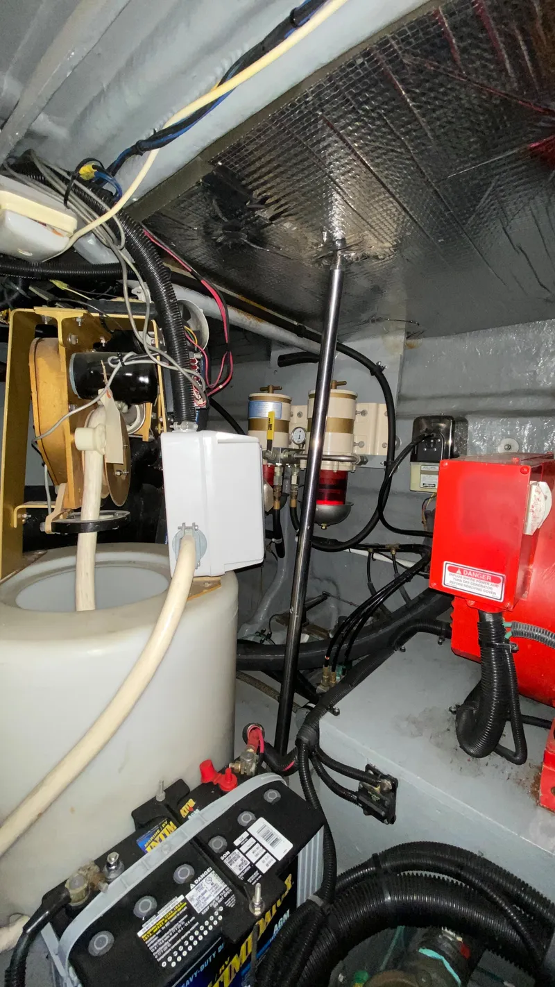 Slide: The Image of Engine room of a 2001 Sea Ray 460 Sundancer boat with various mechanical components. - 35