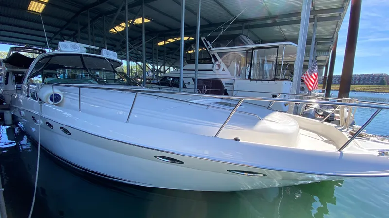 Slide: The Image of 2001 Sea Ray 460 Sundancer yacht docked in a marina. - 41