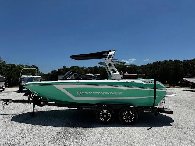 Slide: The Image of 2021 Nautique GS20 boat in mint green on a trailer, side view. - 1