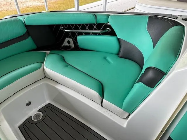 Slide: The Image of 2021 Nautique GS20 boat interior with teal and black seating. - 10