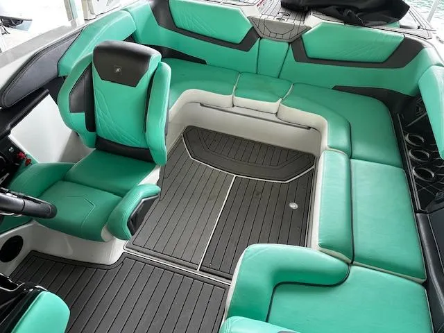 Slide: The Image of 2021 Nautique GS20 boat interior with teal and gray seating. - 14