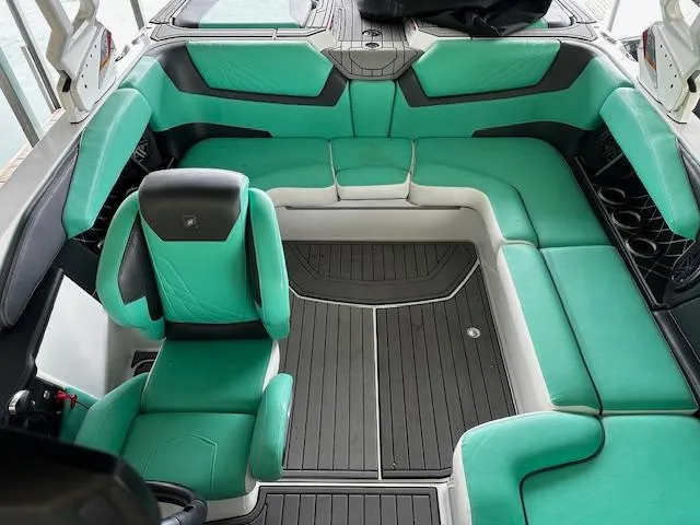 Slide: The Image of 2021 Nautique GS20 boat interior with teal and black seating. - 15