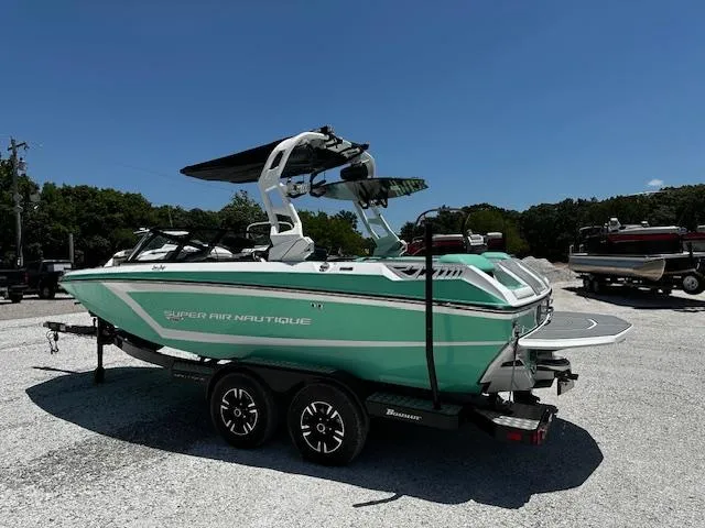 Slide: The Image of 2021 Nautique GS20 boat on trailer in parking lot. - 2