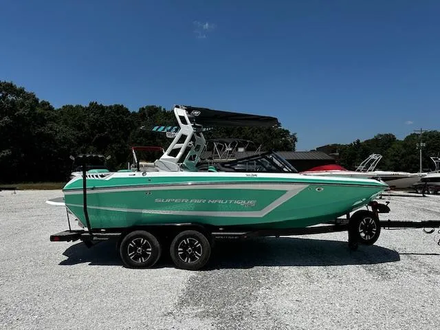 Slide: The Image of 2021 Nautique GS20 boat on a trailer in a parking lot. - 4