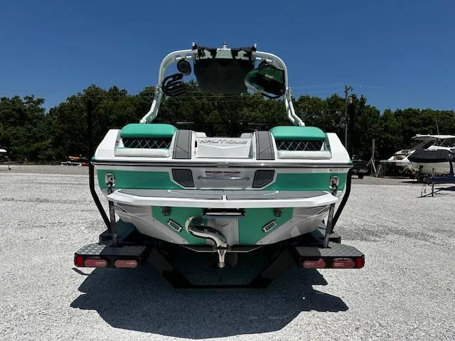 Slide: The Image of 2021 Nautique GS20 boat rear view in a parking lot. - 5