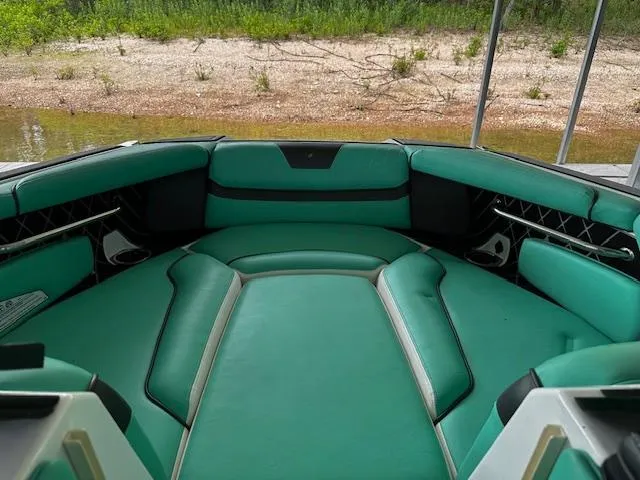 Slide: The Image of 2021 Nautique GS20 boat interior with green seating and black accents. - 8