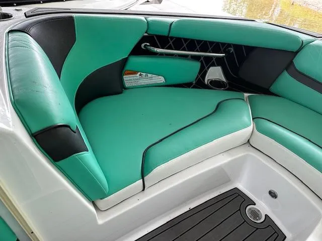 Slide: The Image of 2021 Nautique GS20 boat interior with teal and black seating. - 9