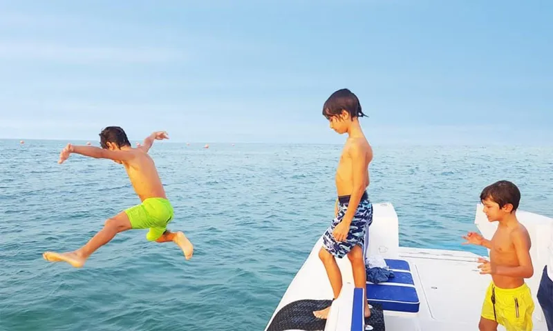 Slide: The Image of Children jumping off 2022 Ocean Craft Marine 9.5 M Beachlander into the sea. - 3