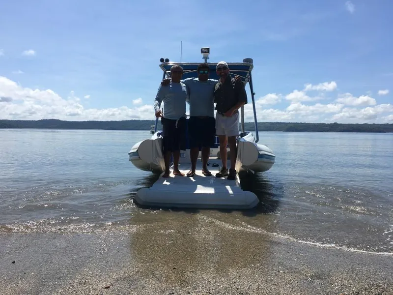 Slide: The Image of Three people standing on an Ocean Craft Marine Beachlander 8.75 boat, 2022 model, at the beach. - 15
