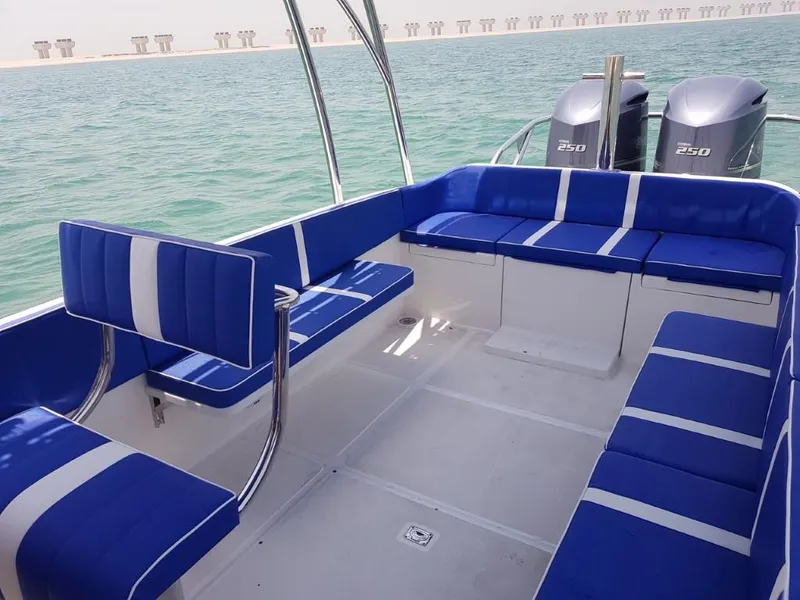 Slide: The Image of 2022 Ocean Craft Marine Beachlander 8.75 interior with blue seating and twin 250 HP engines. - 22