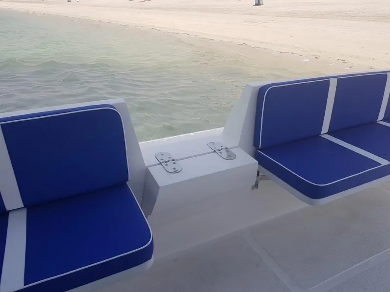 Slide: The Image of Ocean Craft Marine Beachlander 8.75 (2022) boat with blue seating near sandy beach. - 24