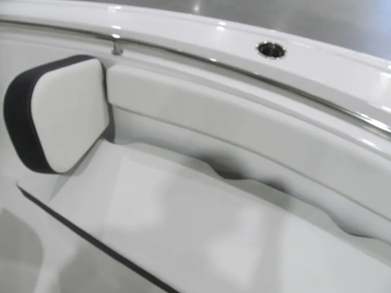 Slide: The Image of 2022 Tidewater 210 LXF boat interior with white cushioned seating. - 10