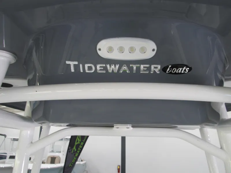 Slide: The Image of 2022 Tidewater 210 LXF boat logo on a sleek gray surface. - 12