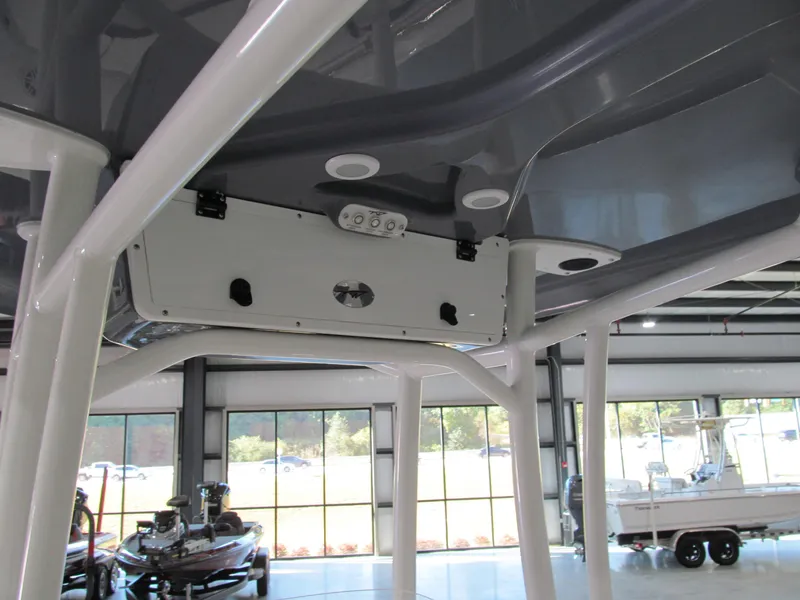Slide: The Image of 2022 Tidewater 210 LXF boat interior, showcasing overhead console and support structure. - 7