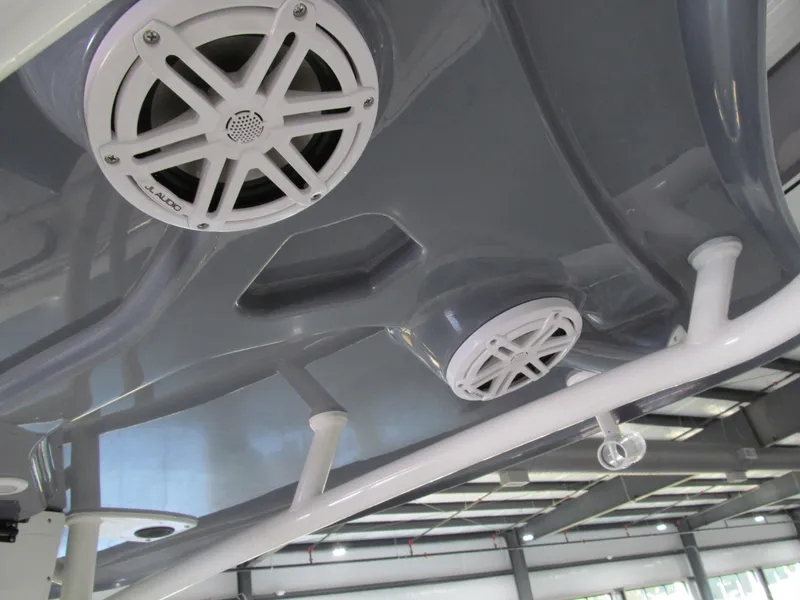 Slide: The Image of 2022 Tidewater 210 LXF boat speakers and canopy detail in a showroom. - 8