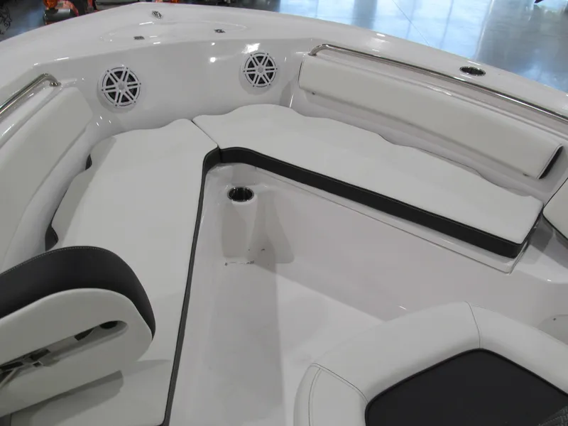 Slide: The Image of 2022 Tidewater 210 LXF boat interior with white seating and cup holders. - 9