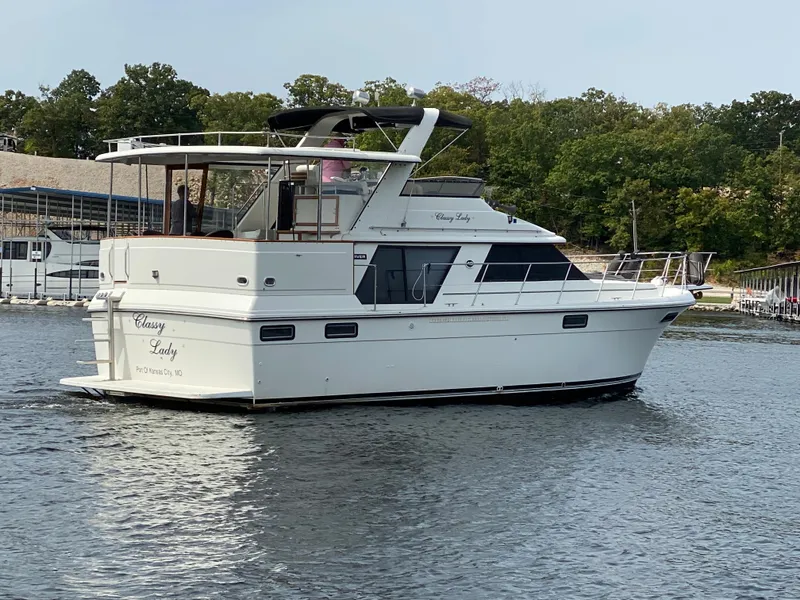 Slide: The Image of 1986 Carver 4207MY yacht cruising on a lake. - 12