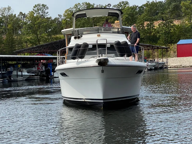 Slide: The Image of 1986 Carver 4207MY yacht on water with people onboard. - 18