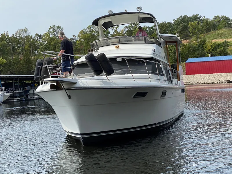 Slide: The Image of 1986 Carver 4207MY yacht on water with people onboard. - 20