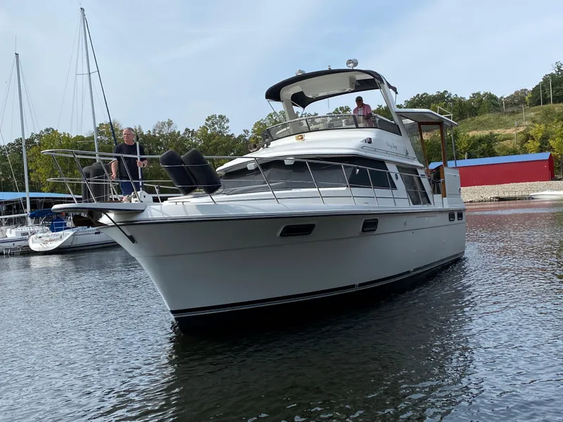 Slide: The Image of 1986 Carver 4207MY yacht on water with people onboard. - 21