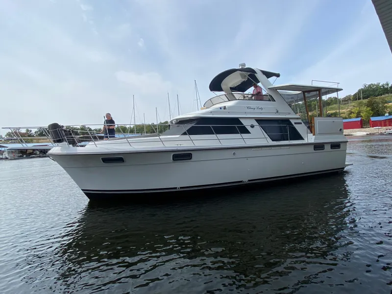 Slide: The Image of 1986 Carver 4207MY yacht on calm water with clear sky. - 25