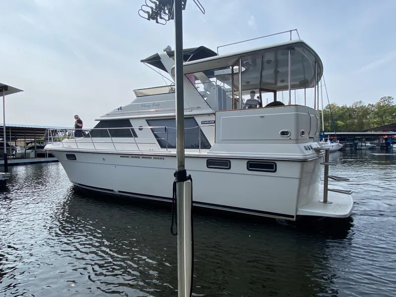 Slide: The Image of 1986 Carver 4207MY yacht docked in a marina. - 26