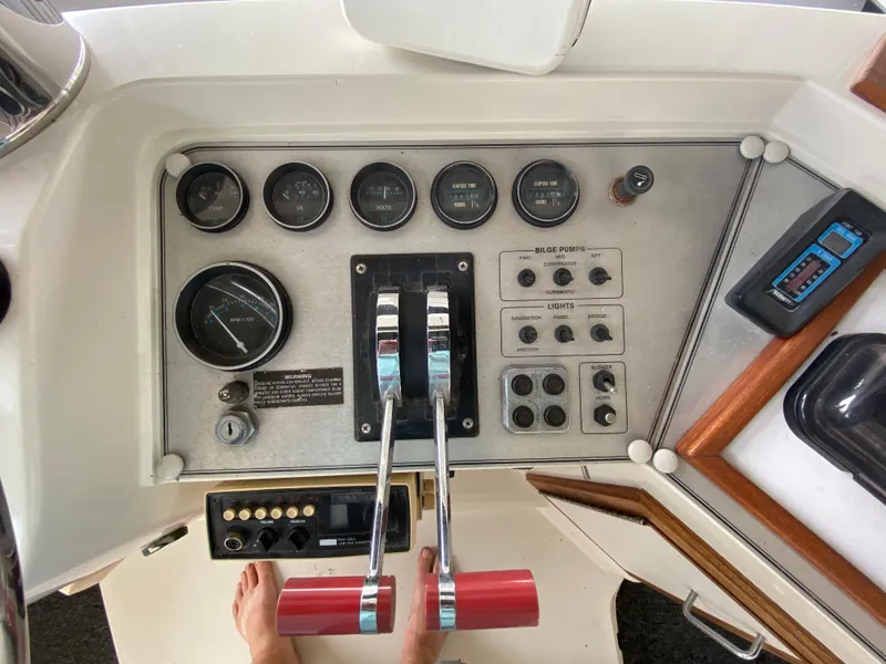 Slide: The Image of 1986 Carver 4207MY boat control panel with gauges and throttle levers. - 44