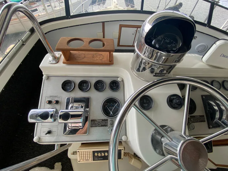 Slide: The Image of 1986 Carver 4207MY boat helm with steering wheel and control panel. - 48