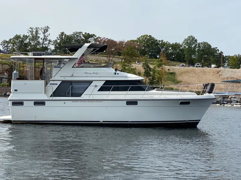 Slide: The Image of 1986 Carver 4207MY yacht on water with trees in background. - 9