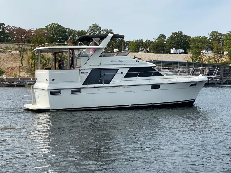 Slide: The Image of 1986 Carver 4207MY yacht cruising on a lake. - 10