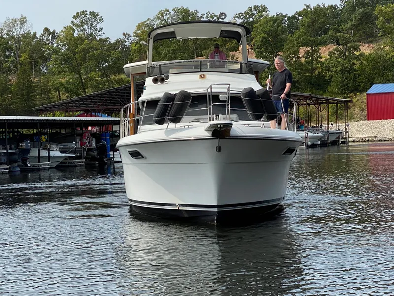 Slide: The Image of 1986 Carver 4207MY yacht on a lake with people onboard. - 17