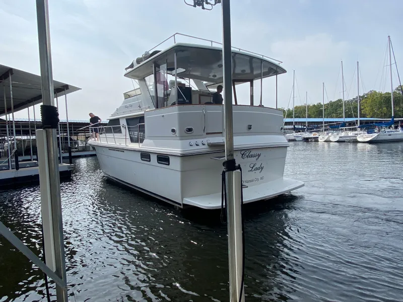 Slide: The Image of 1986 Carver 4207MY yacht named Classy Lady docked at a marina. - 28