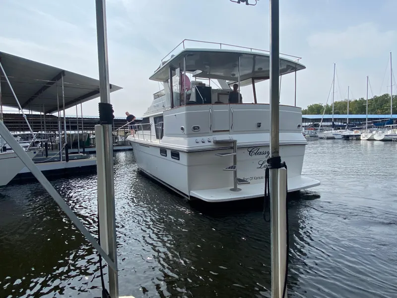 Slide: The Image of 1986 Carver 4207MY yacht docked at a marina. - 29