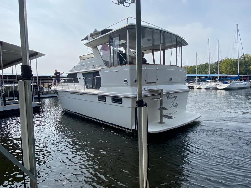 Slide: The Image of 1986 Carver 4207MY yacht docked at a marina. - 31