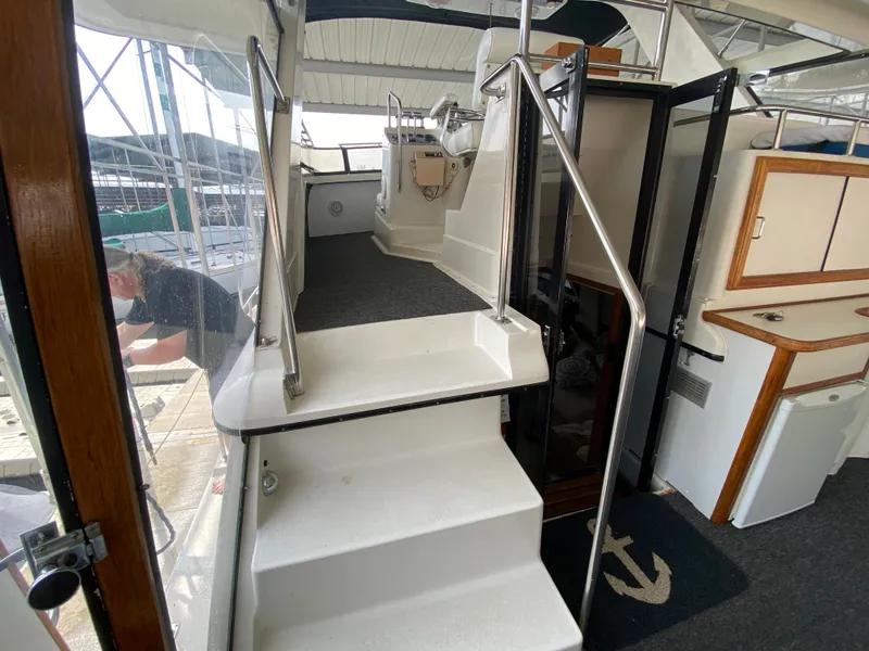 Slide: The Image of 1986 Carver 4207MY yacht interior with stairs leading to the helm station. - 37