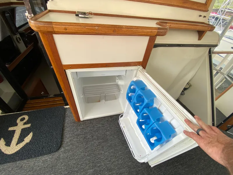 Slide: The Image of 1986 Carver 4207MY yacht interior with open mini fridge and anchor mat. - 38