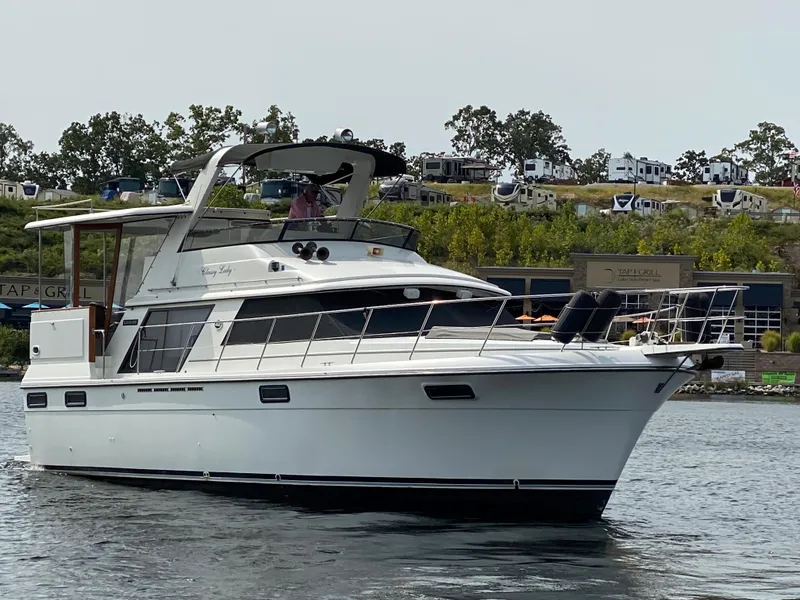 Slide: The Image of 1986 Carver 4207MY yacht cruising on a lake. - 6