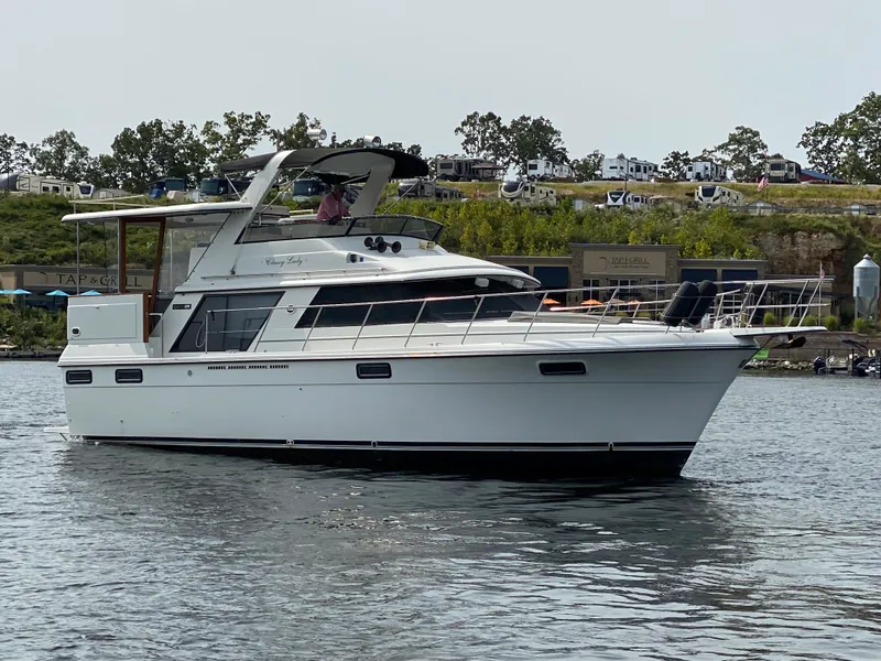 Slide: The Image of 1986 Carver 4207MY yacht cruising on a calm lake. - 7
